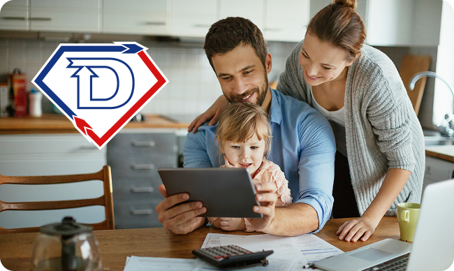 A smiling family of three looks at a tablet together in a kitchen. Papers, a calculator, and a laptop are on the table. A “D” logo is shown in the top left corner.